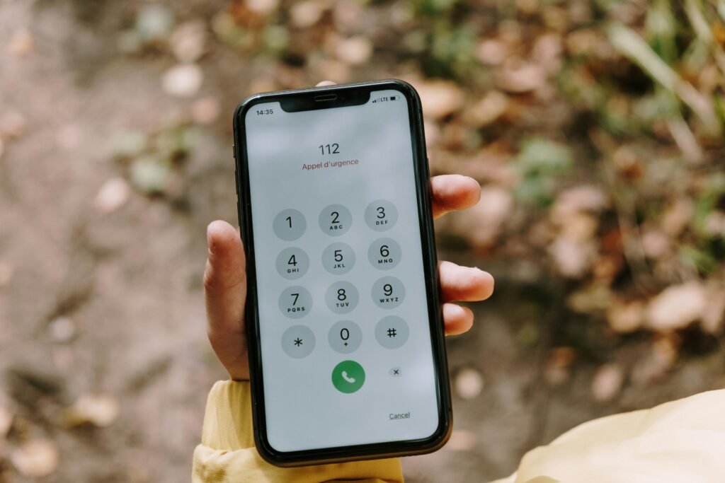 Person using smartphone to call emergency services